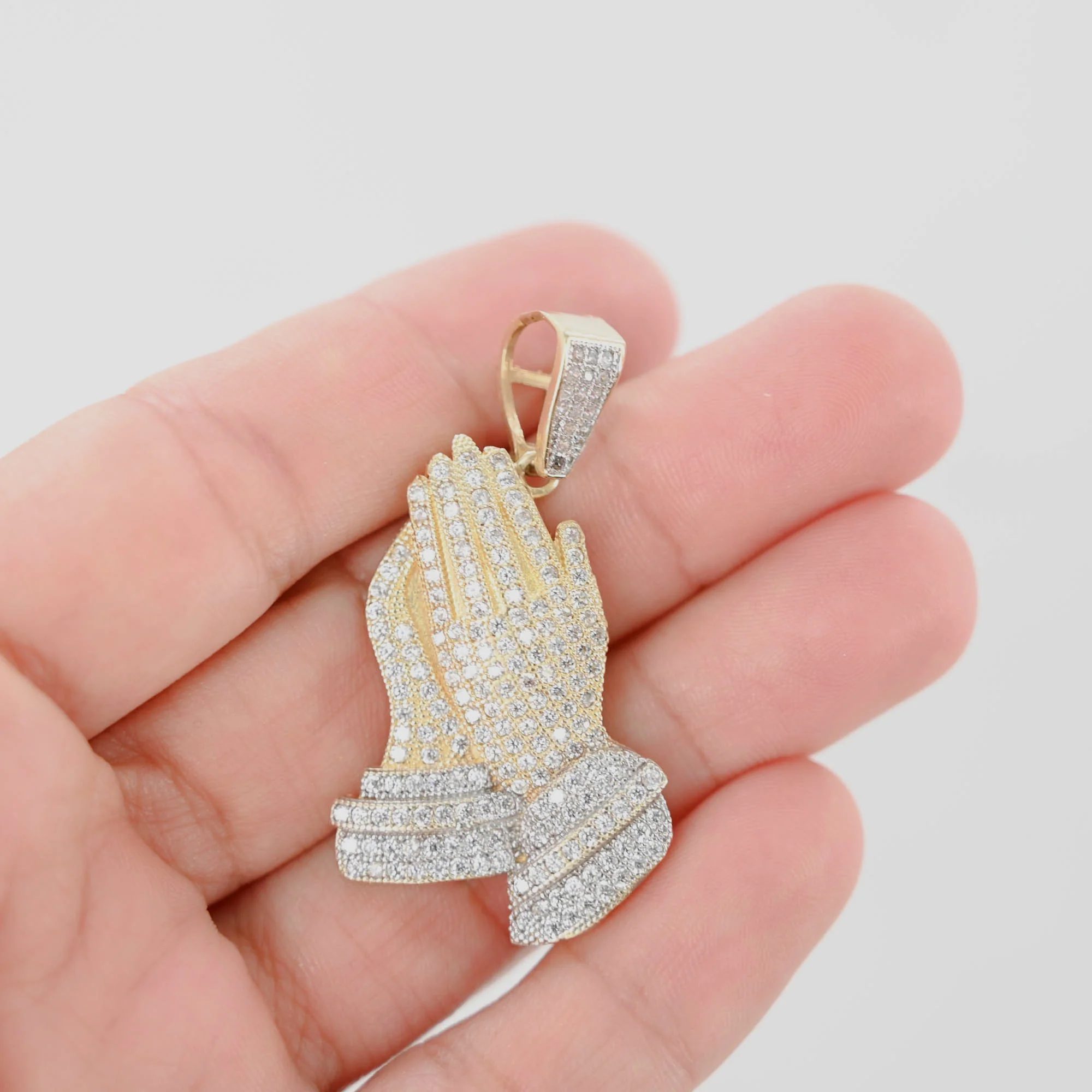 Custom diamond hand pendant in palm